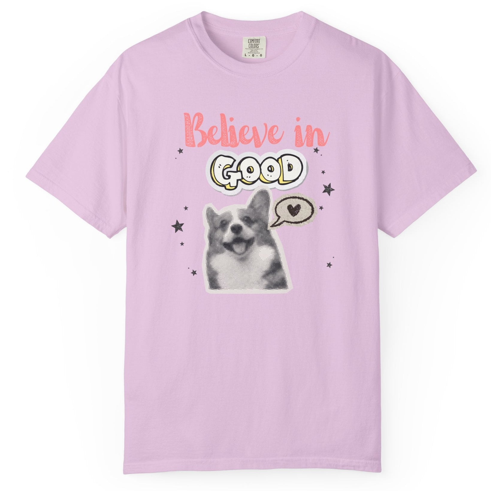 Pink t-shirt with a dog graphic and 'Believe in Good' text on a white background